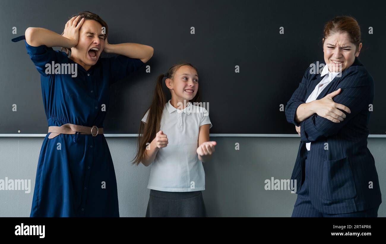 Schoolgirl and her mother yell at the teacher standing at the ...