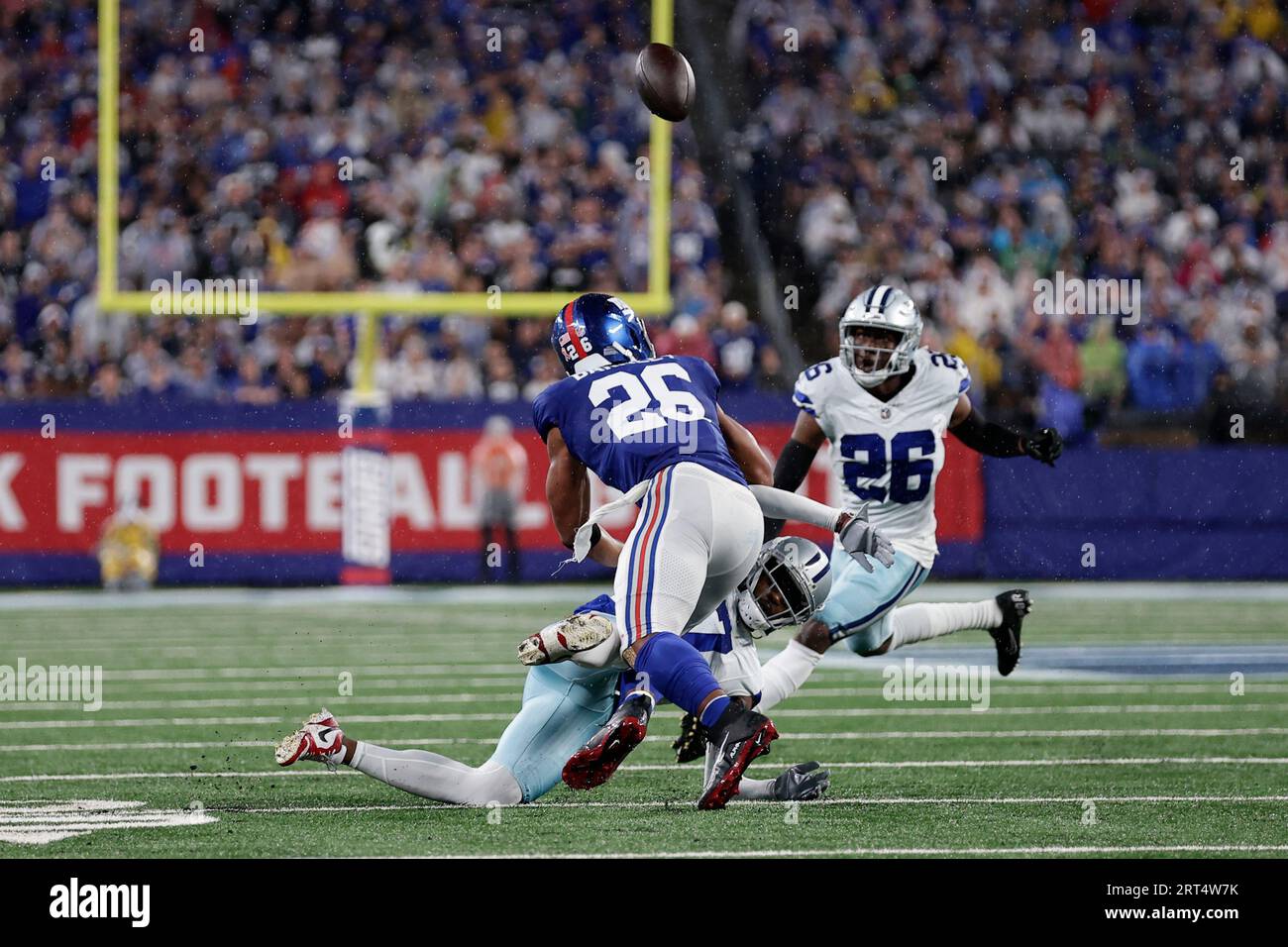 Dallas Cowboys' DaRon Bland, right, intercepts a pass intended for New York  Giants' Saquon Barkley, left, during the first half of an NFL football  game, Sunday, Sept. 10, 2023, in East Rutherford,