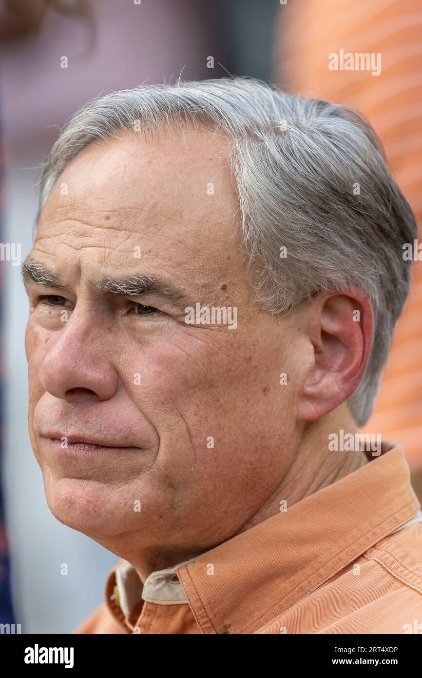 Texas Gov. Greg Abbott visits the field during warmups before an NCAA
