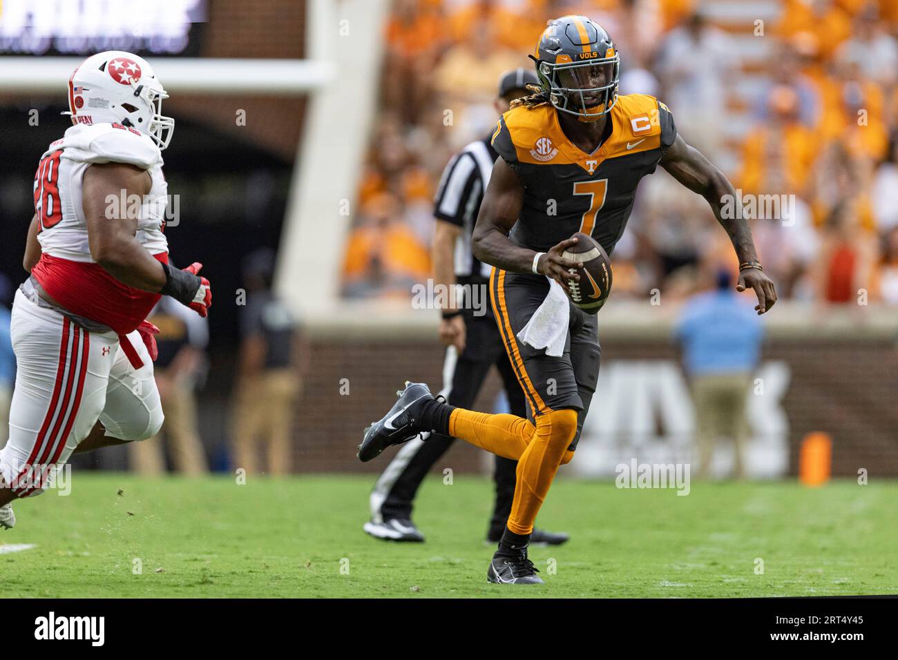 Tennessee quarterback Joe Milton III (7) runs for yardage as hes chased by Austin Peay defensive lineman Gardy Paul (28) during the first half of an NCAA college football game Saturday, Sept.