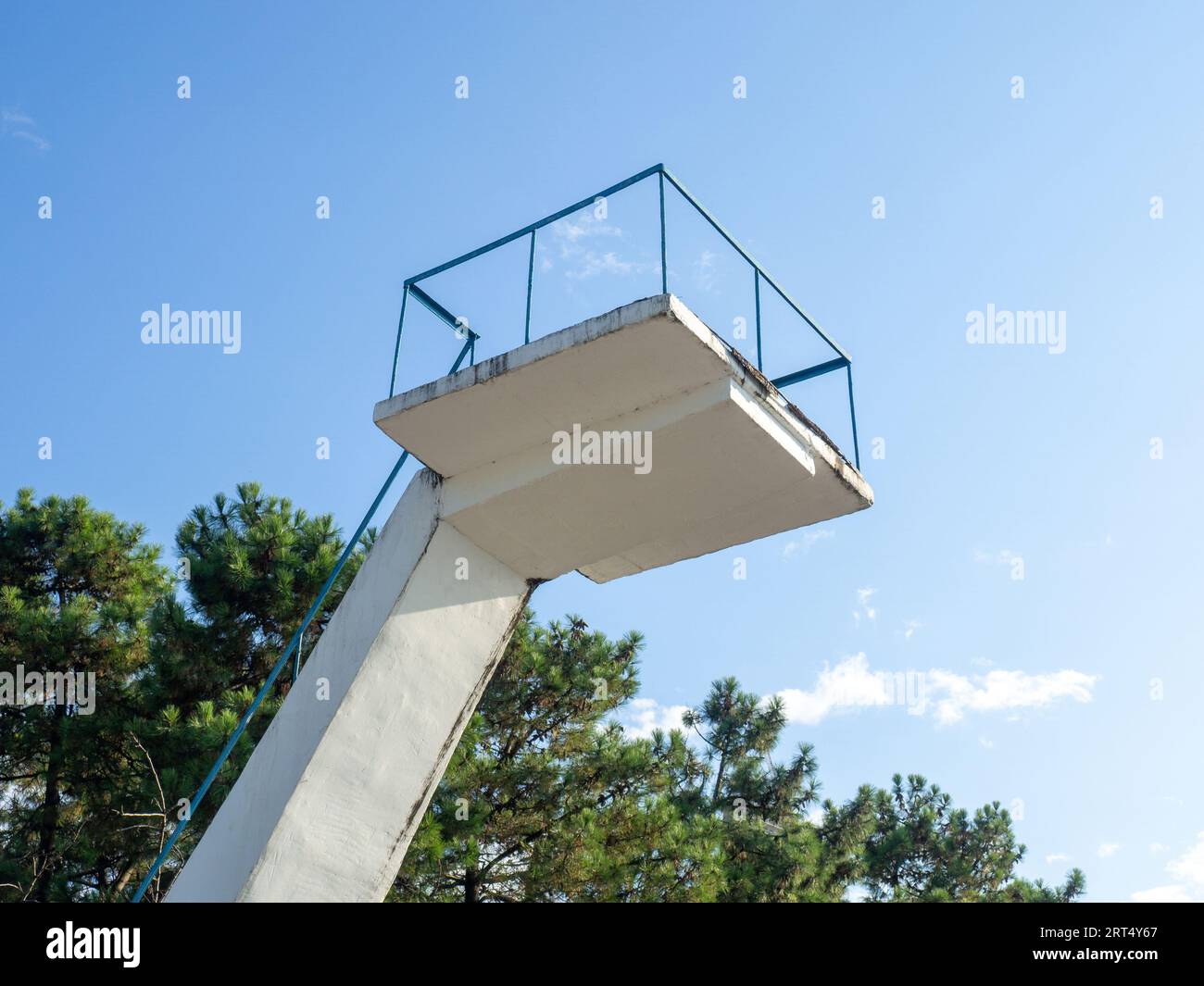 Old diving board. Cement tower on the beach. Against the sky. Resort infrastructure. In a