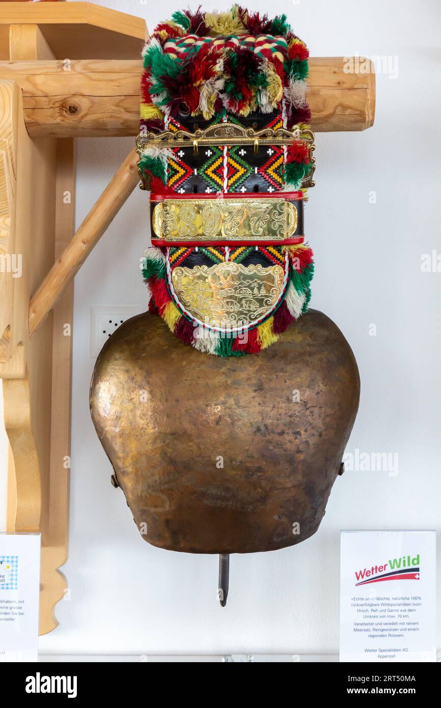 A photograph of a colorful traditional Swiss cowbell souvenir on