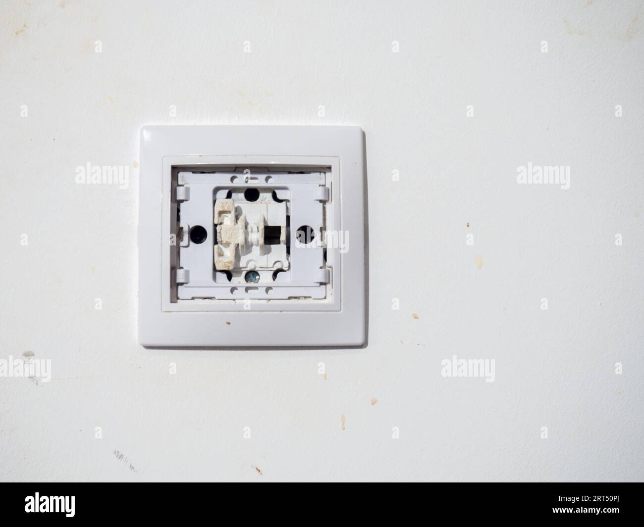 Broken electrical switch on the wall. Switch without button
