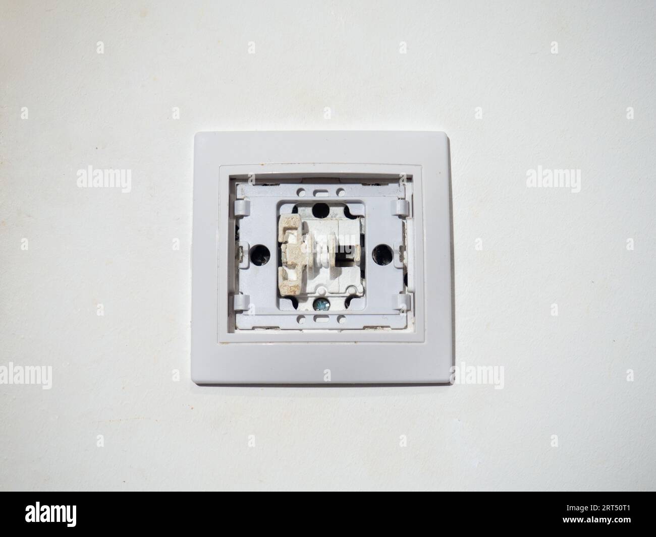 Broken electrical switch on the wall. Switch without button