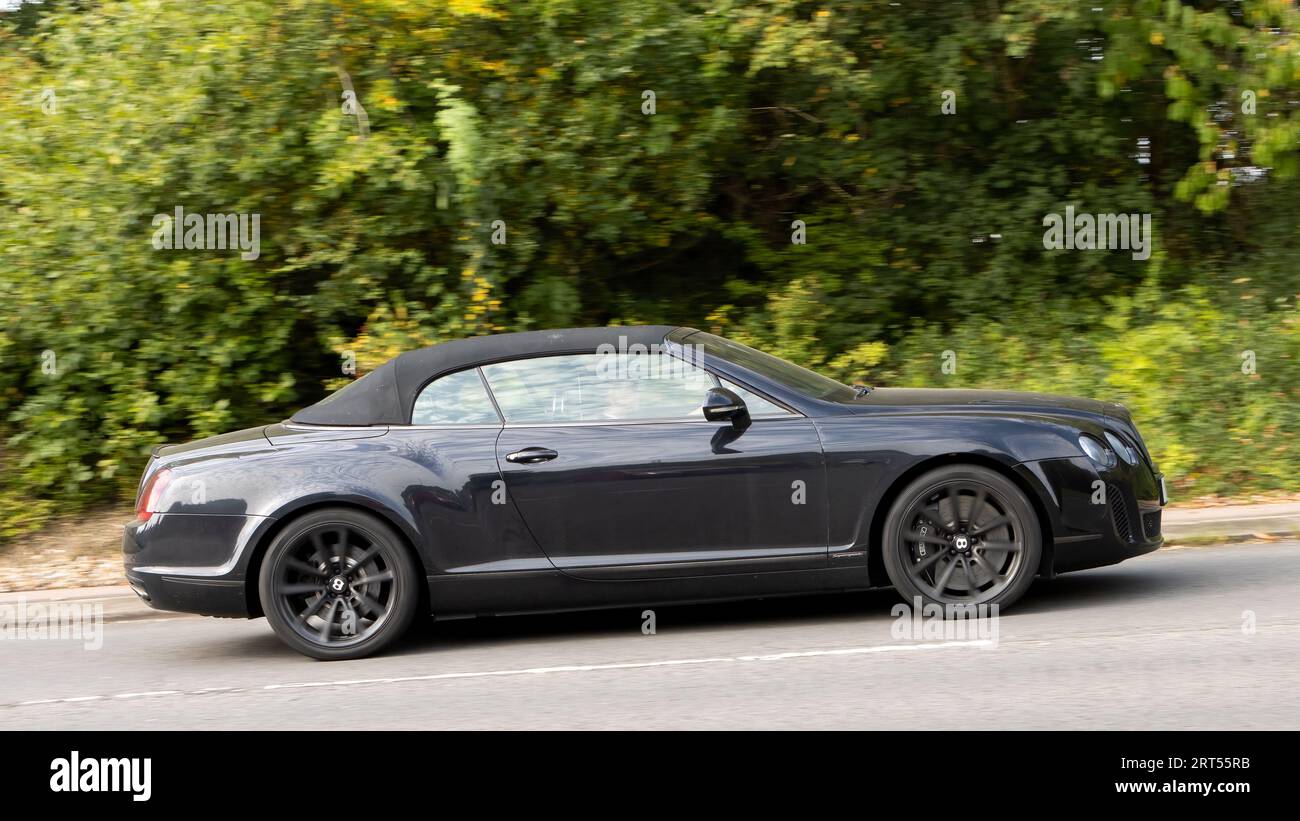 Milton Keynes,UK-Sept 10th 2023: 2011 black Bentley Continental luxury  car travelling on an English road. Stock Photo