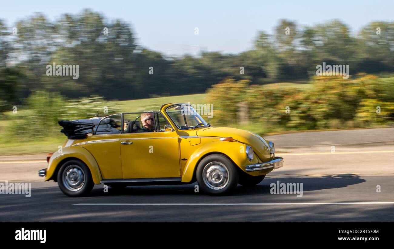 Milton Keynes,UK - Sept 4th 2023: 1975 yellow Volkswagen Beetle convertible car with the top down Stock Photo