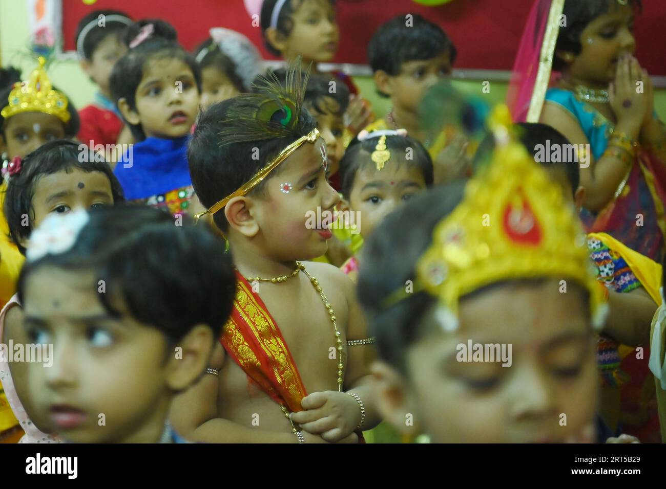 Students of the 'My Chota’’ pre-School dress up as Hindu deity 'Krishna', on the eve of the Krishna Janmashtami Festival at Agartala. Tripura. India. Stock Photo
