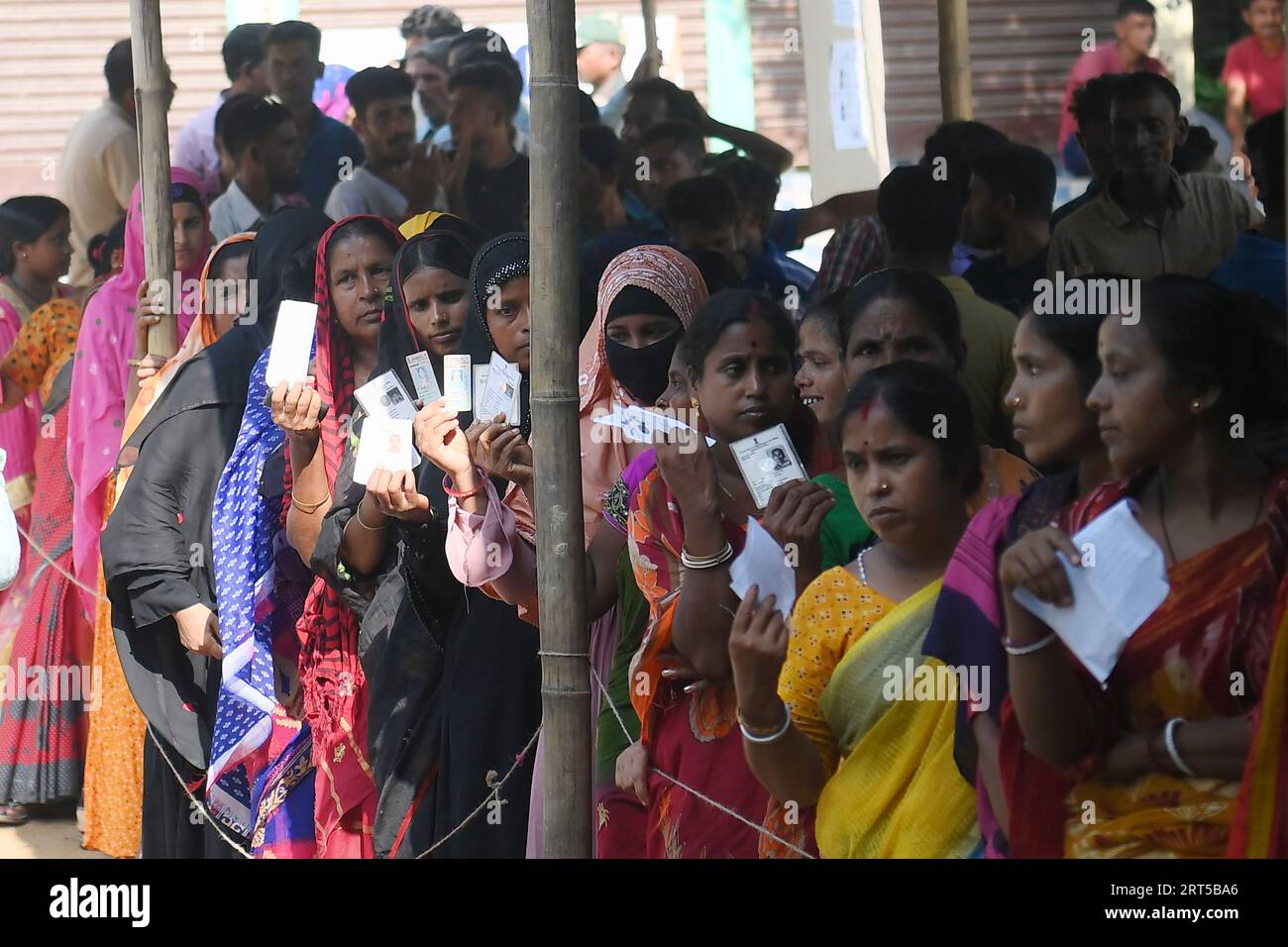 Voters wait in a queue to cast their votes during the by-elections for the Boxonagar assembly seat, in Tripura Sepahijala district. Agartala. Tripura. India. Stock Photo