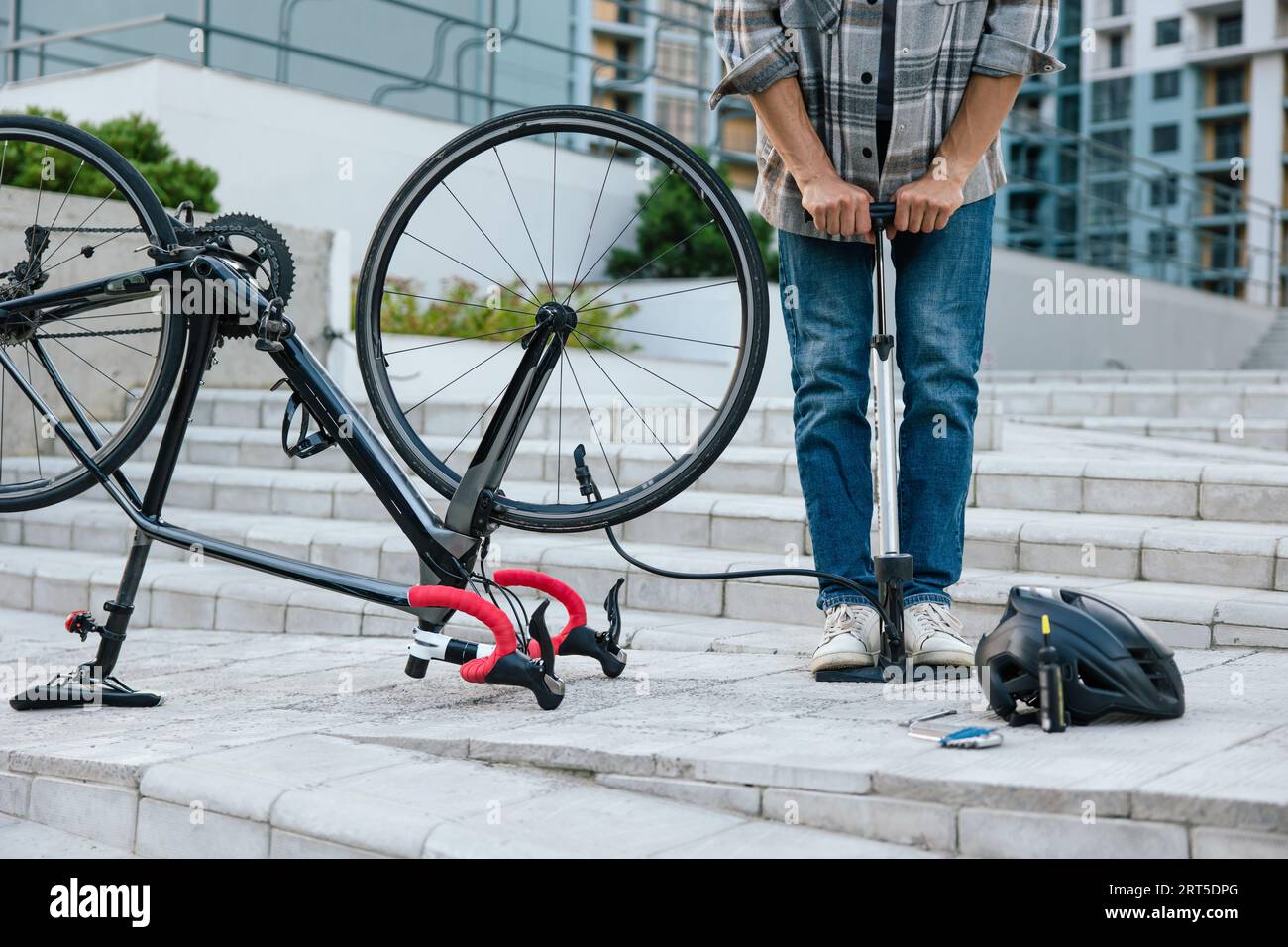 Young man fixing a problem with the tire Stock Photo - Alamy