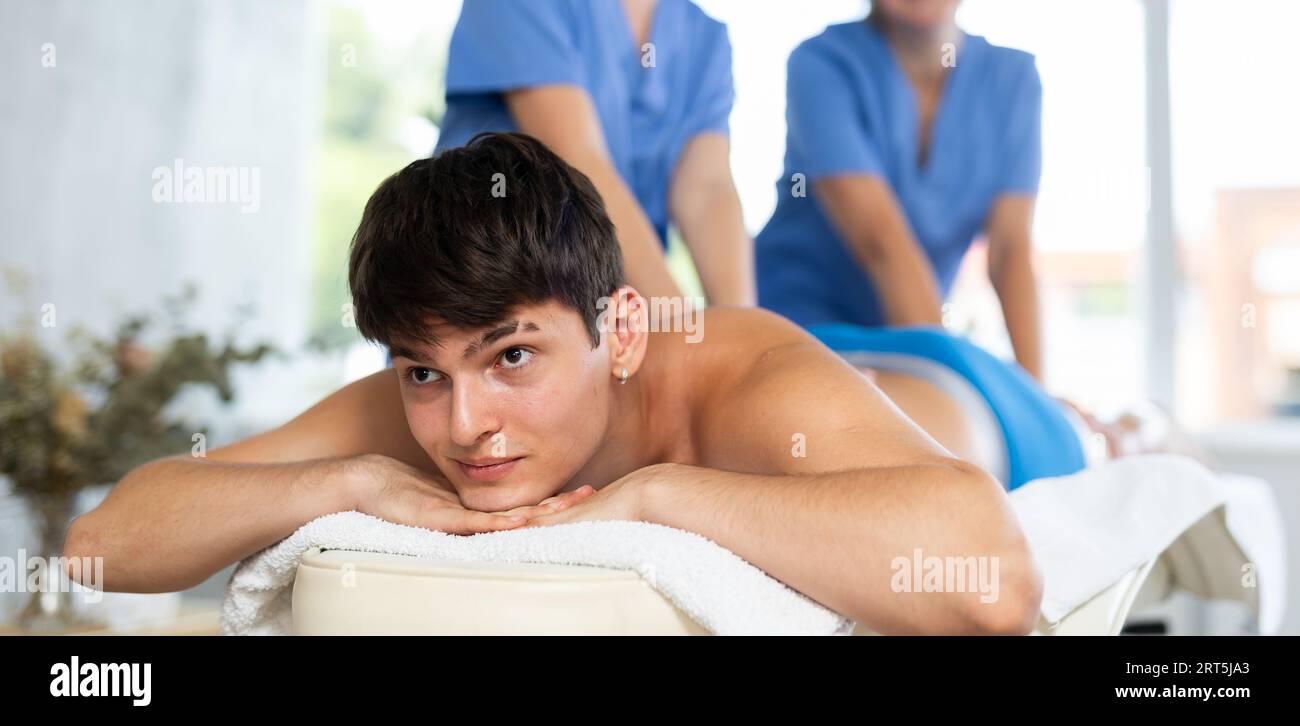 A woman giving a man shoulder massage Stock Photo - Alamy