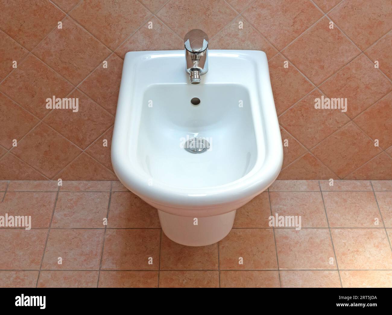 Wall mounted white ceramic bidet, Italian bathroom Stock Photo Alamy