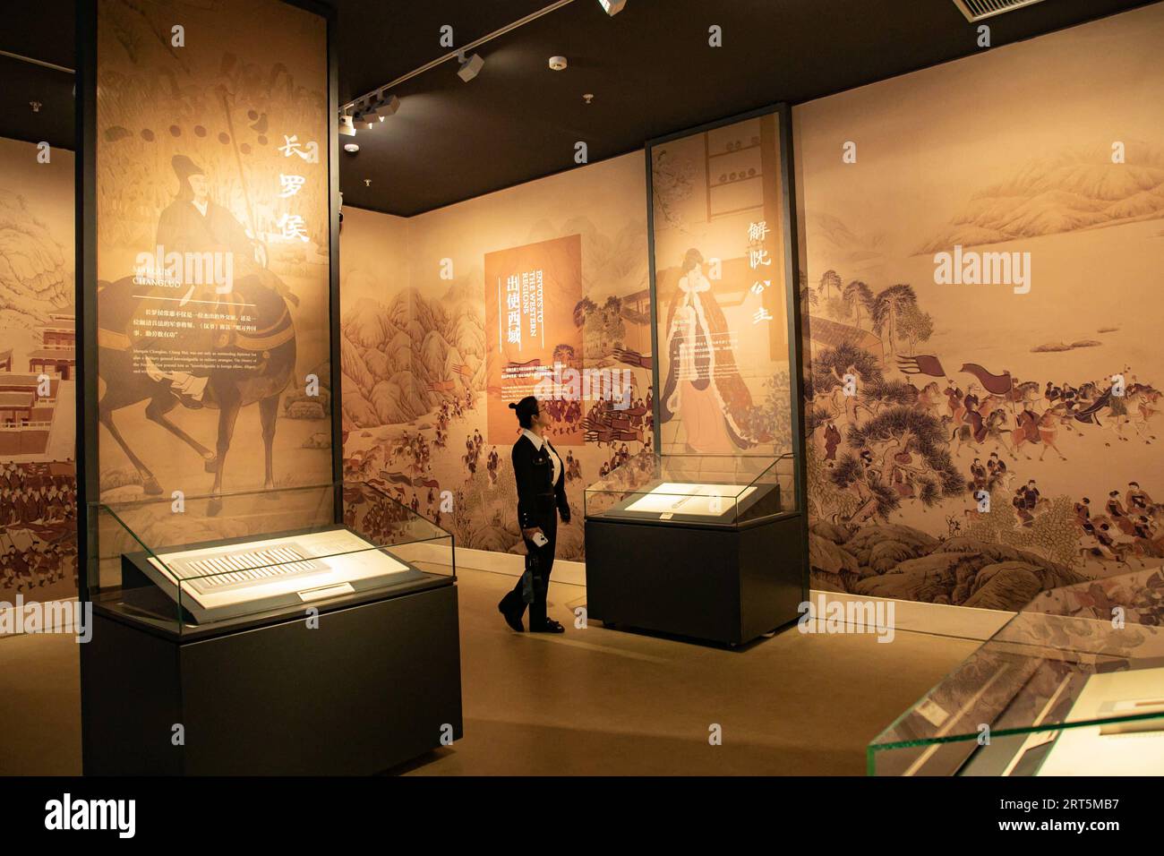 230907 -- LANZHOU, Sept. 7, 2023 -- A visitor views exhibits at the new hall of Gansu bamboo slip museum in Lanzhou, northwest China s Gansu Province, Sept. 7, 2023. The new hall of a bamboo slip museum in Gansu opened on Thursday, with more than 1,000 ancient bamboo slips on display. Most of these slips are being showcased for the first time since they were discovered, including those dating back some 2,000 years to the Han Dynasty 202 BC-AD 220. Located along the Hexi Corridor, part of the ancient Silk Road in northwest China, Gansu has a dry climate, and therefore, the ancient bamboo slips Stock Photo