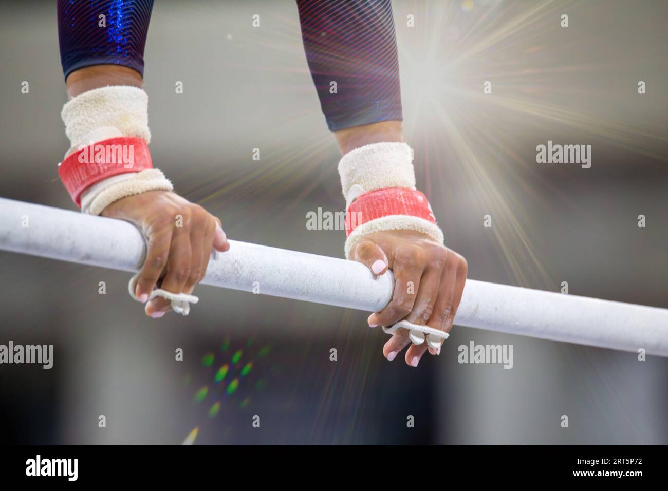 Symbol image of apparatus gymnastics: close-up of a gymnast on the uneven bars Stock Photo