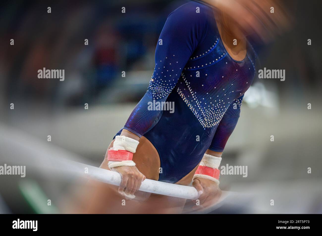 Symbol image of apparatus gymnastics: close-up of a gymnast on the uneven bars Stock Photo