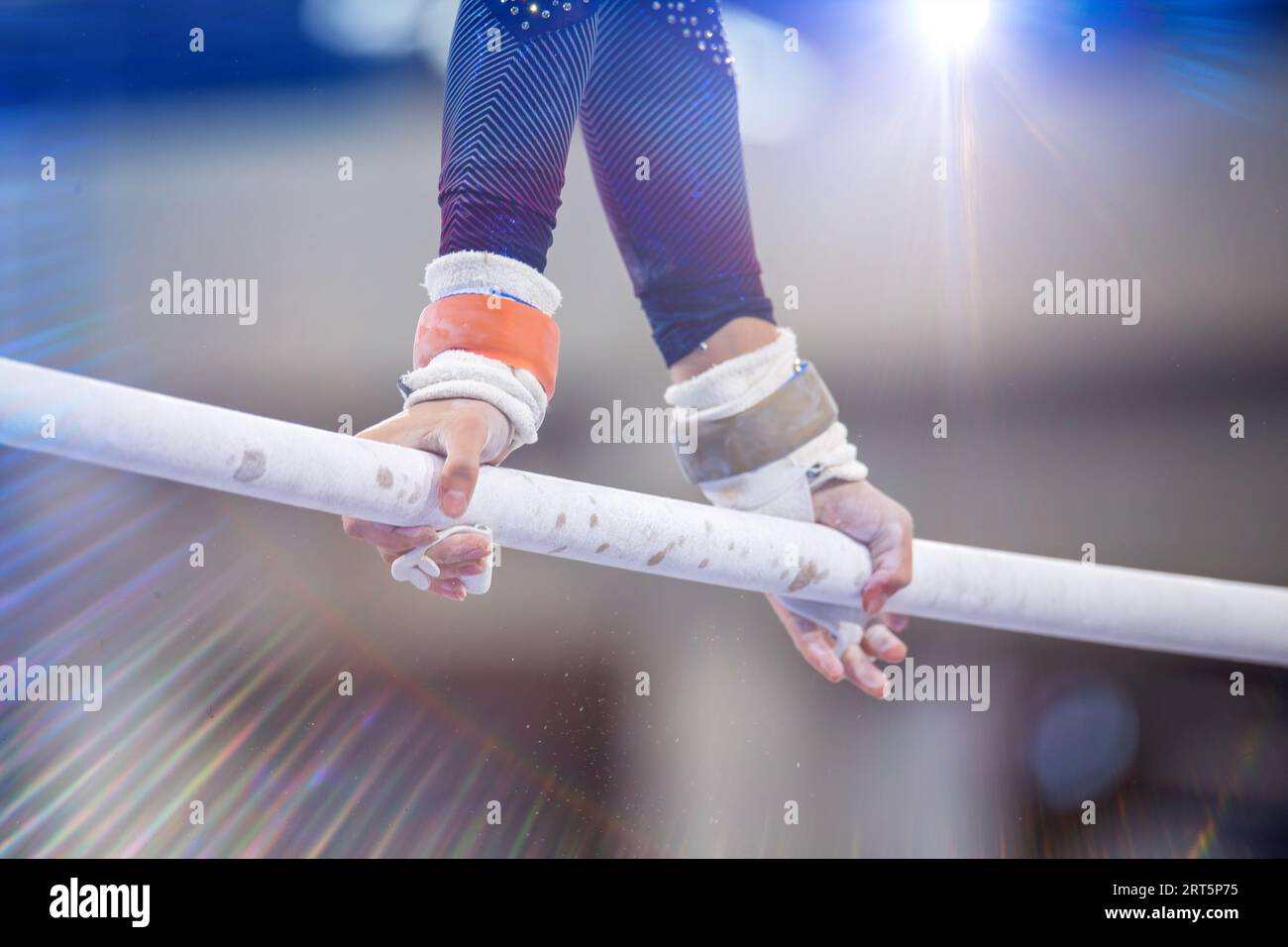 Symbol image of apparatus gymnastics: close-up of a gymnast on the uneven bars Stock Photo