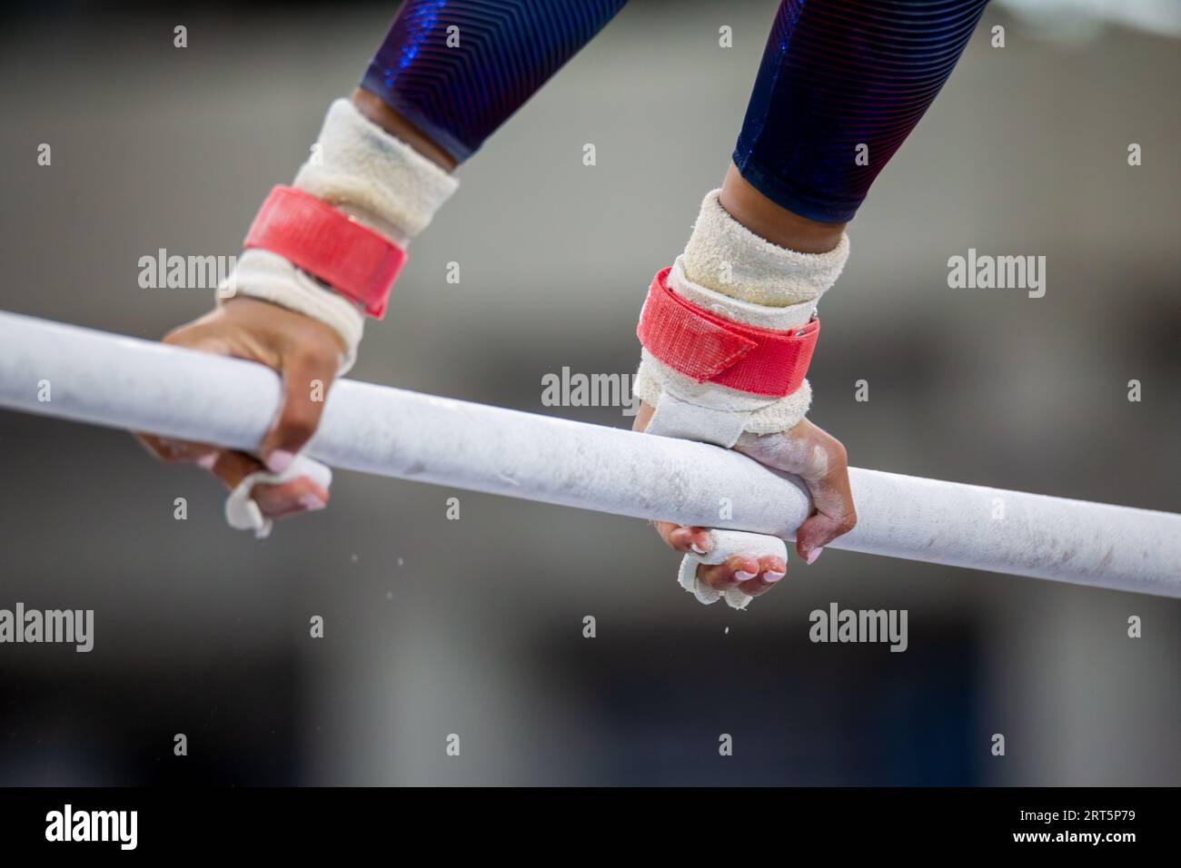 Symbol image of apparatus gymnastics: close-up of a gymnast on the uneven bars Stock Photo