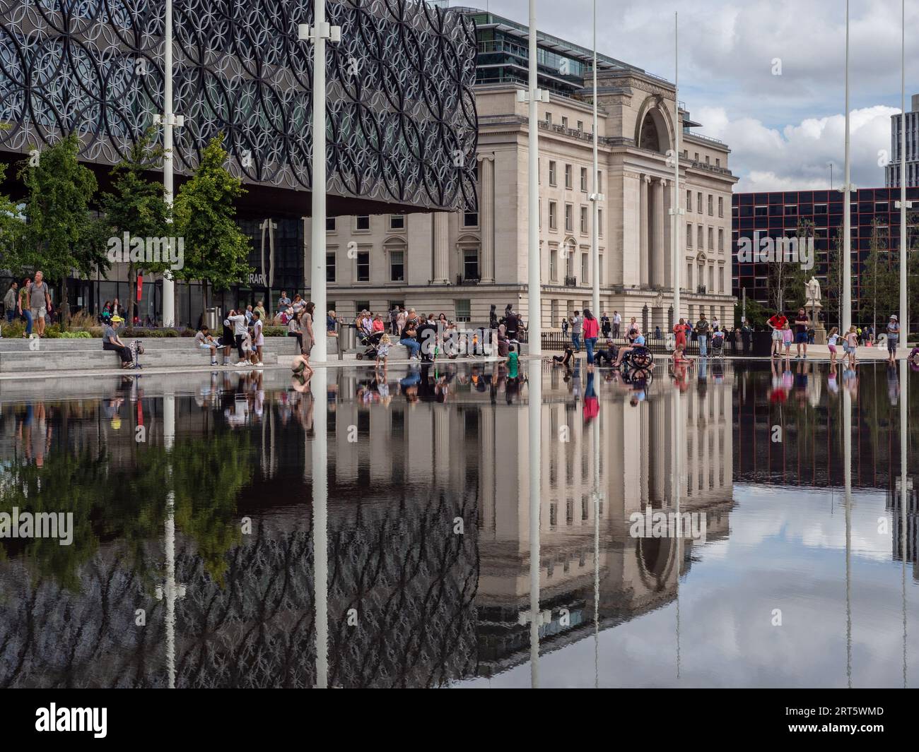 Centenary Square, Birmingham, UK; reflections of the Library of Birmingham and Baskerville House in a shallow ornamental pool. Stock Photo