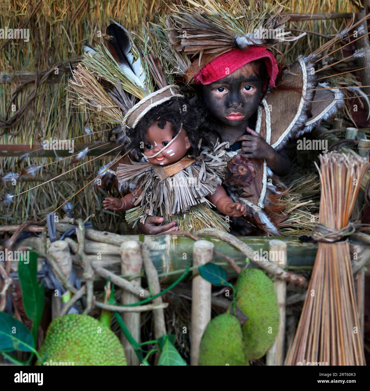 Baby girl with doll as symbol of Santo Nino figur at Ati Atihan
