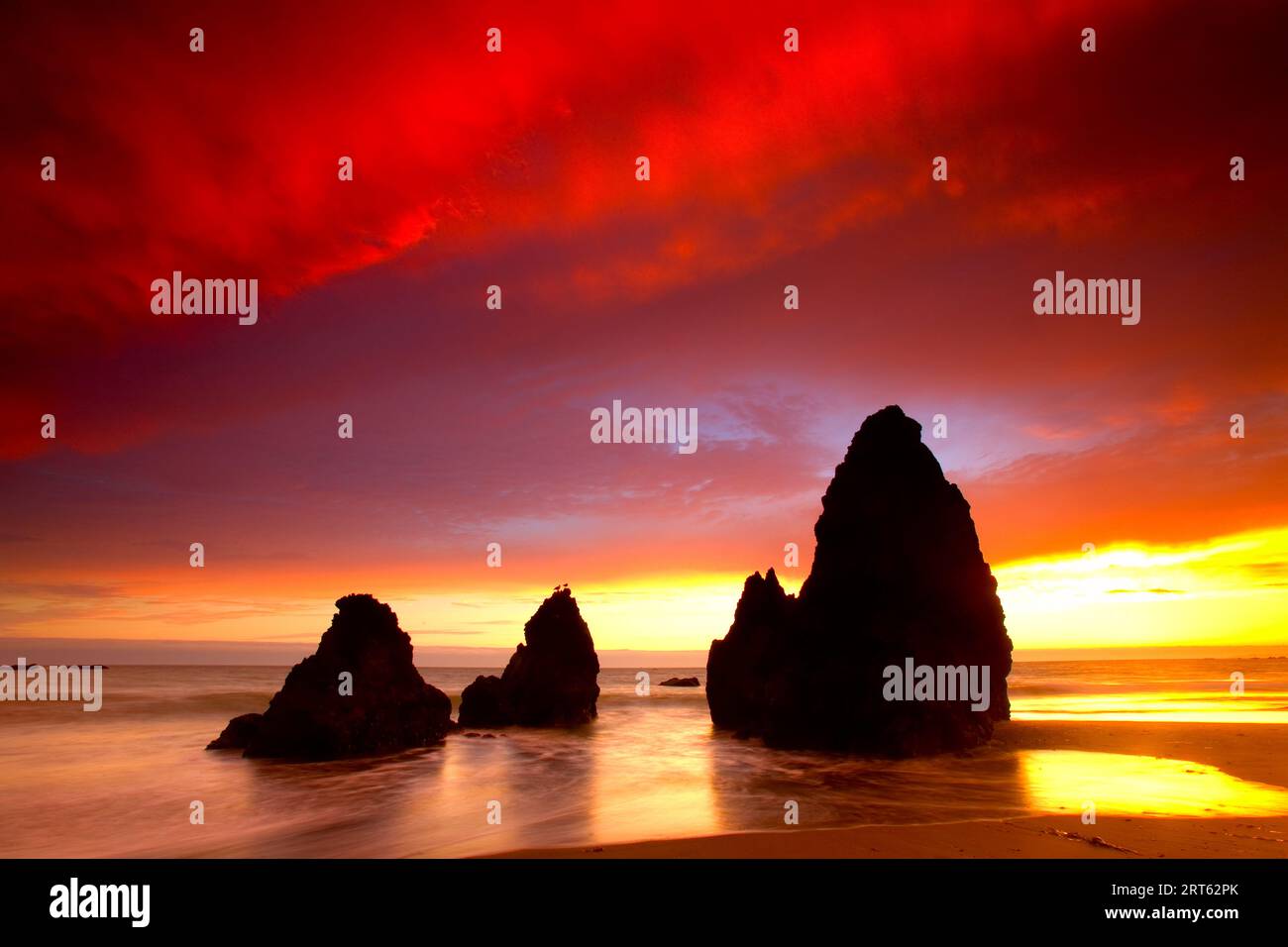 Sea Stacks silhouetted against a summer sunset at Rodeo Beach located in Northern California in the Marin Headlands. Stock Photo