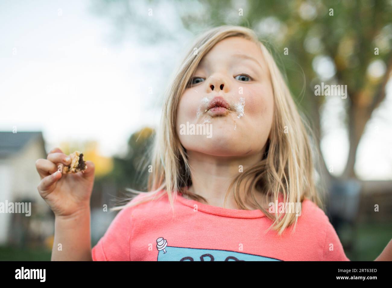Toddler with messy s’more face shows off treat. Stock Photo