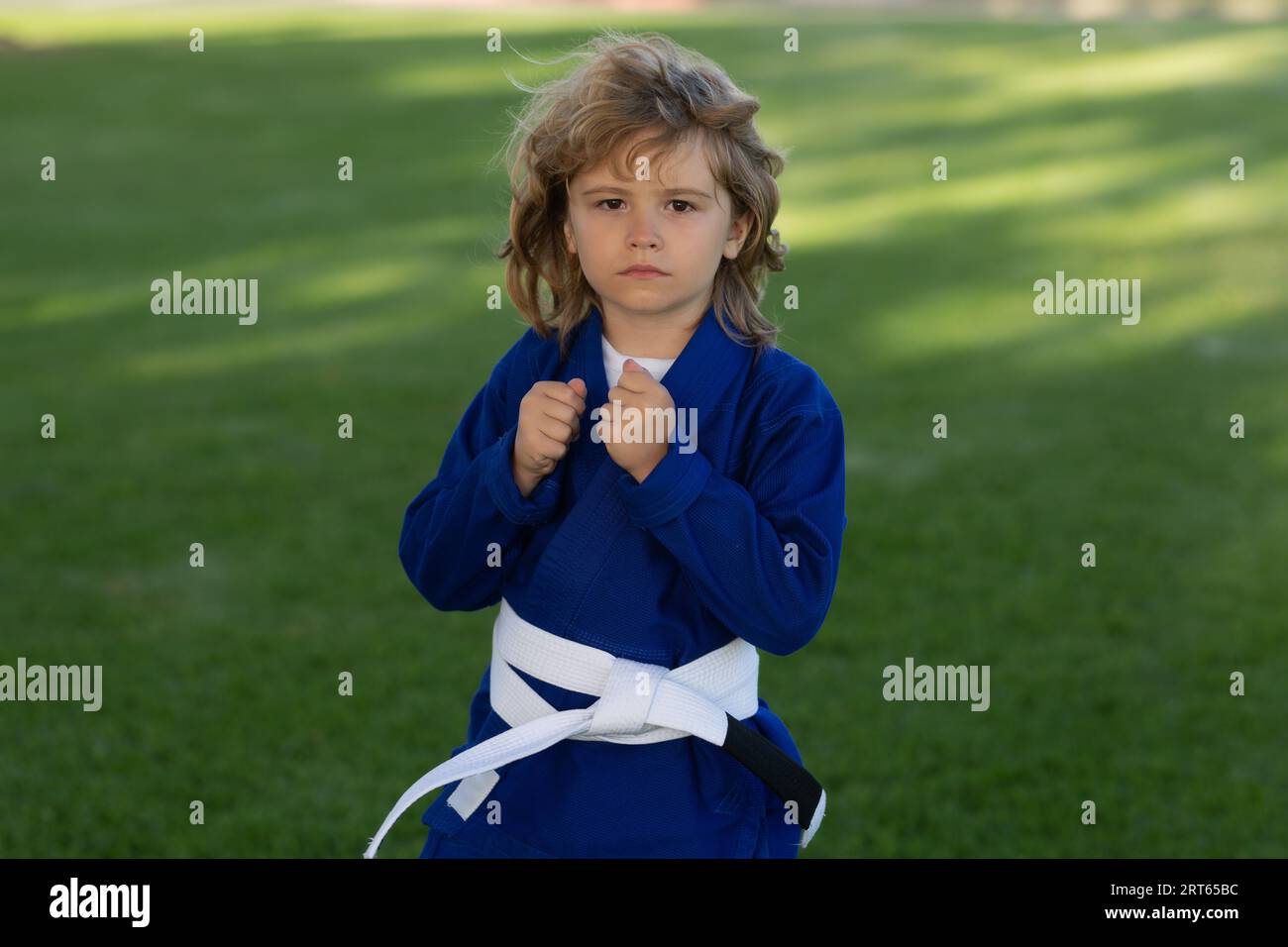Kid boy practicing karate outdoor. Sport karate kids. Little boy