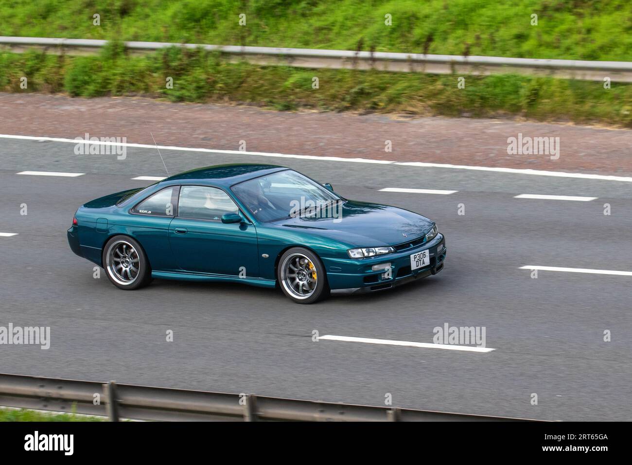1997 90s nineties Green Nissan 200 SX  two-door coupe; travelling at speed on the M6 motorway in Greater Manchester, UK Stock Photo