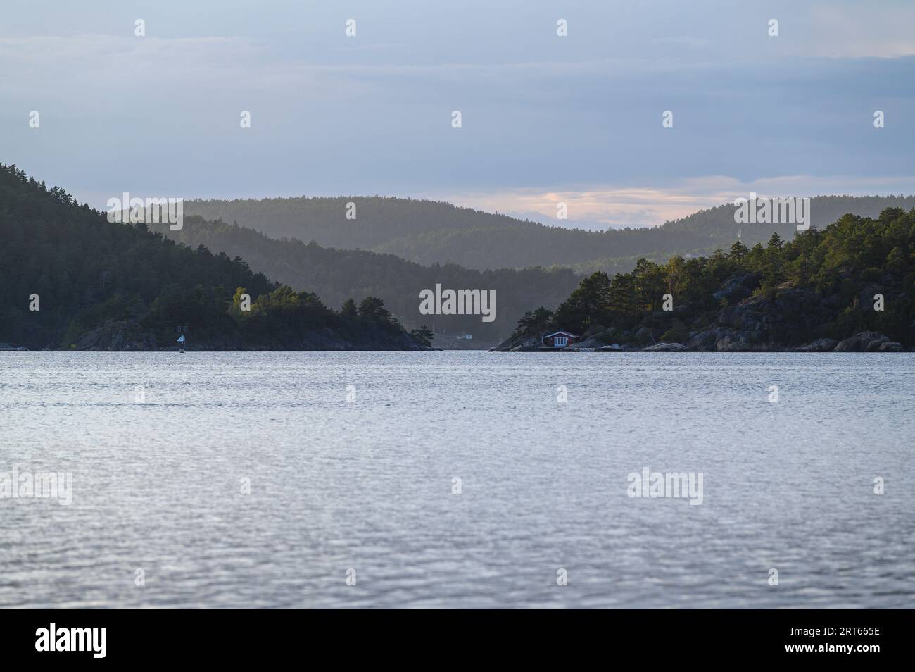 Islands of the Kragero archipelago appear fading in layers in the evening low sunlight. Telemark county, Norway. Stock Photo