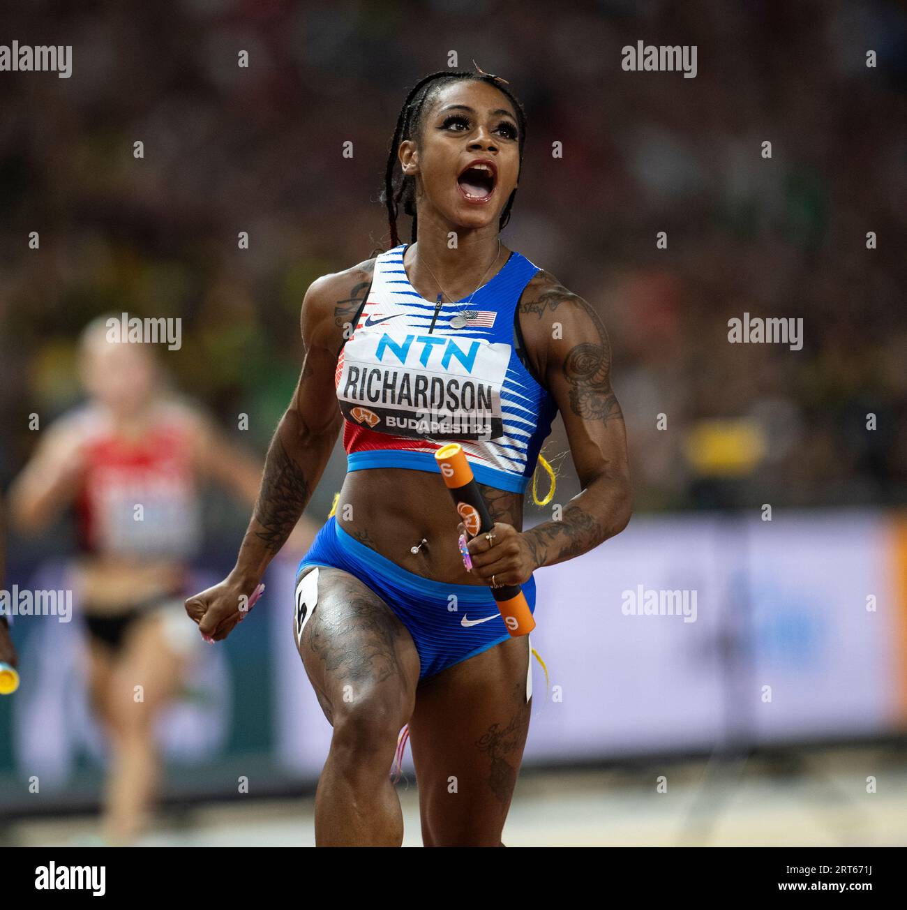 Sha'Carri Richardson of team USA competing in the 4x100m relay on day