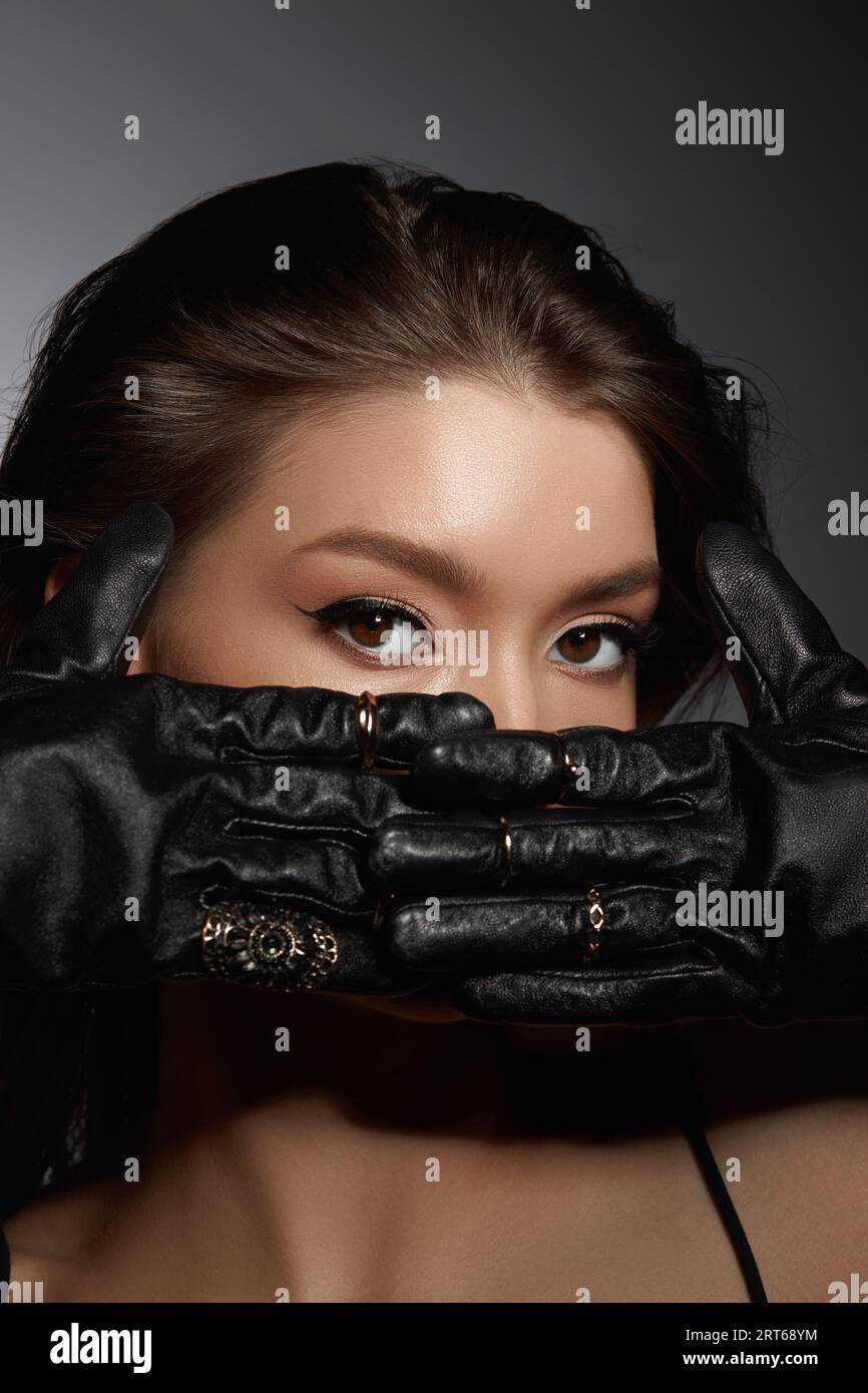 Fashion Woman in black gloves, portrait. Long hair, beauty beautiful eyes Stock Photo