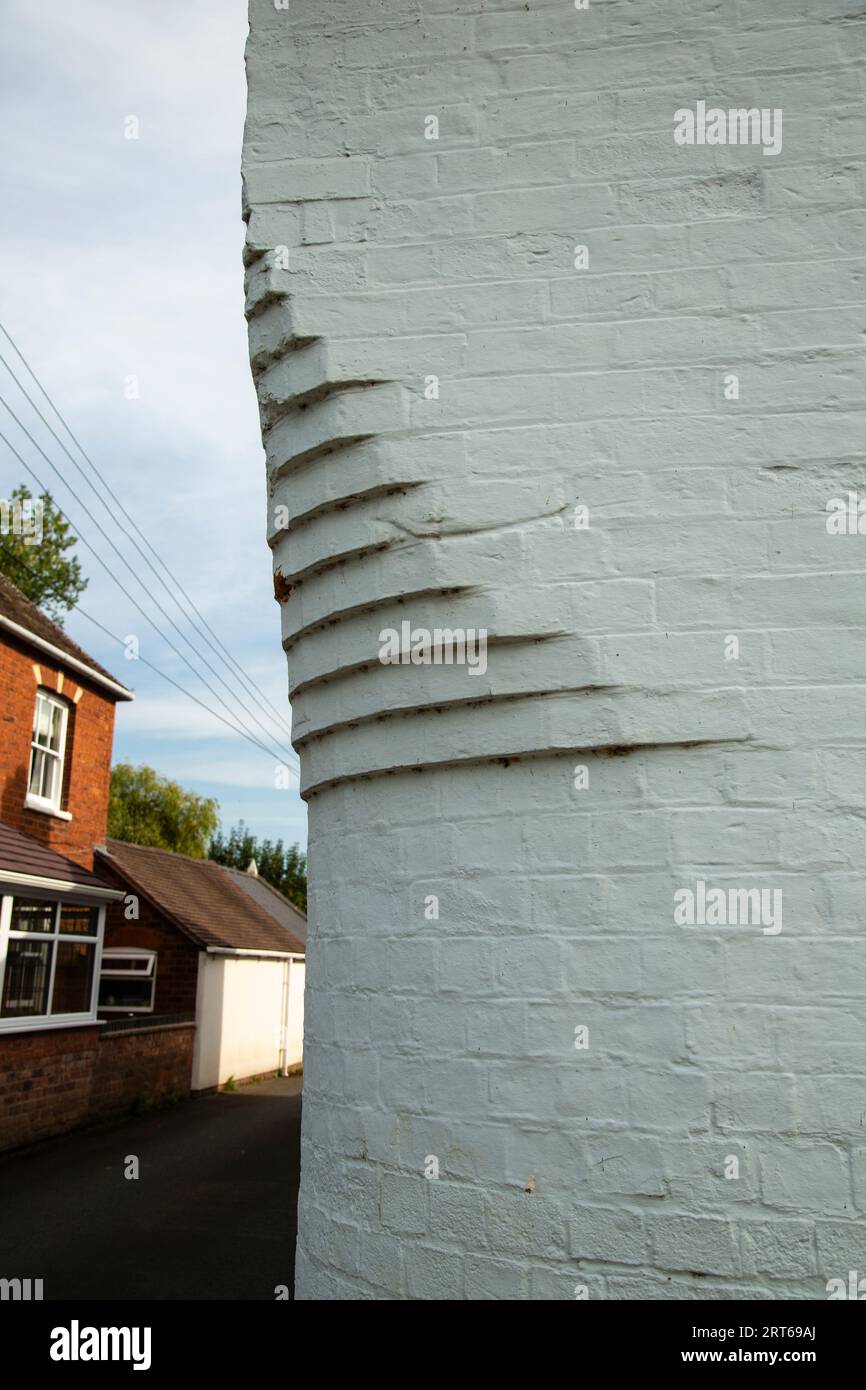 Corbelling on the corner of a building to avoid damage by vehicles turning into a narrow lane. Stock Photo