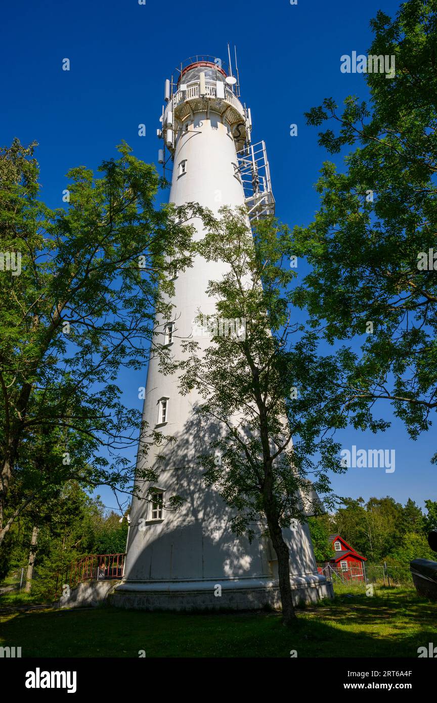 The active lighthouse (built 1939) sit in a forest glade on the long and narrow Jomfruland island, Telemark, Norway. Stock Photo