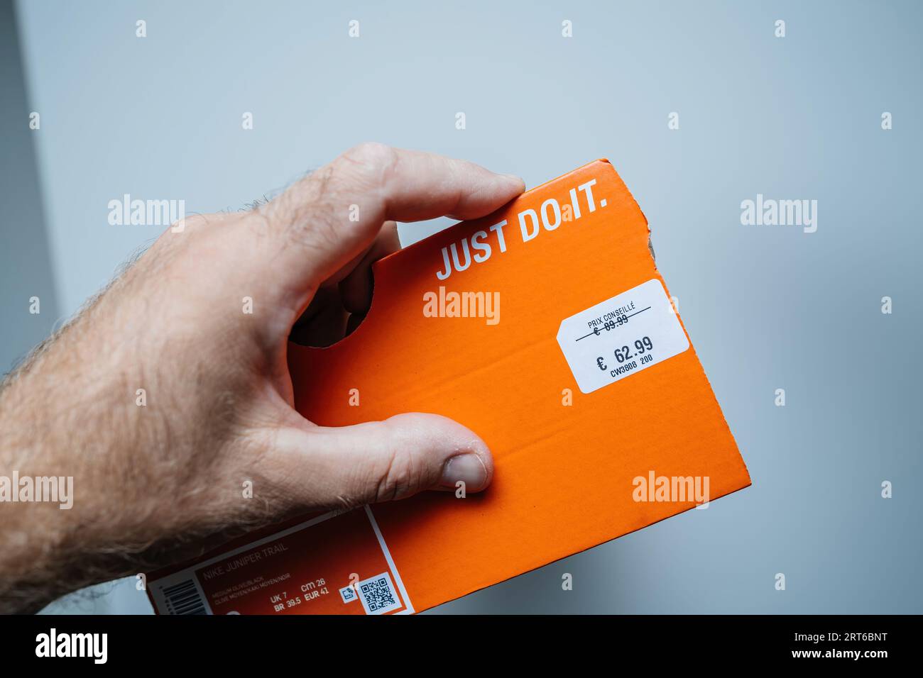 Paris, France - Jul 12, 2023: POV male hand shows the package proudly  displaying a pair of Nike shoes, revealing a discounted price tag that's  been slashed from 82.99 to just 62.99 Stock Photo - Alamy