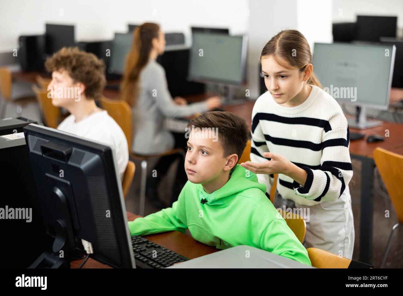 Boy helping friend computer hi-res stock photography and images - Alamy