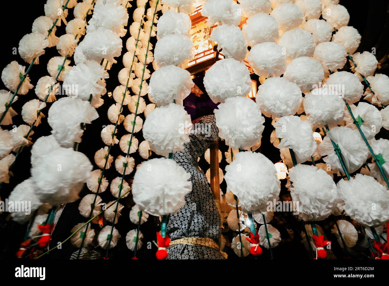 Tokyo, Japan. October 12, 2022 : Japanese men carry sacred lanterns decorated with paper cherry blossoms in Oeshiki Festival at Ikegami Temple, Tokyo, Stock Photo