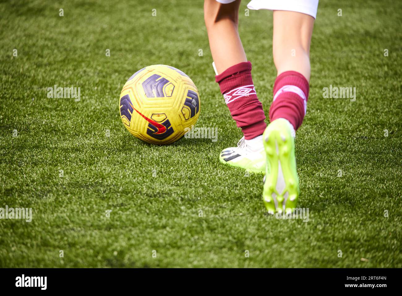 Close up of feet playing football, in West Ham colours Stock Photo