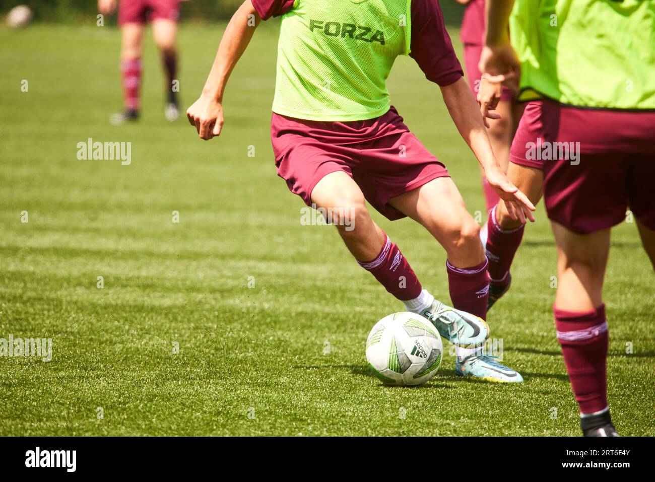 Close up of feet playing football, in West Ham colours Stock Photo
