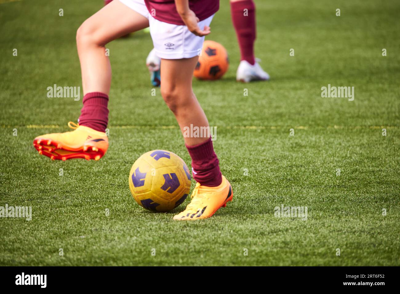Close up of feet playing football, in West Ham colours Stock Photo