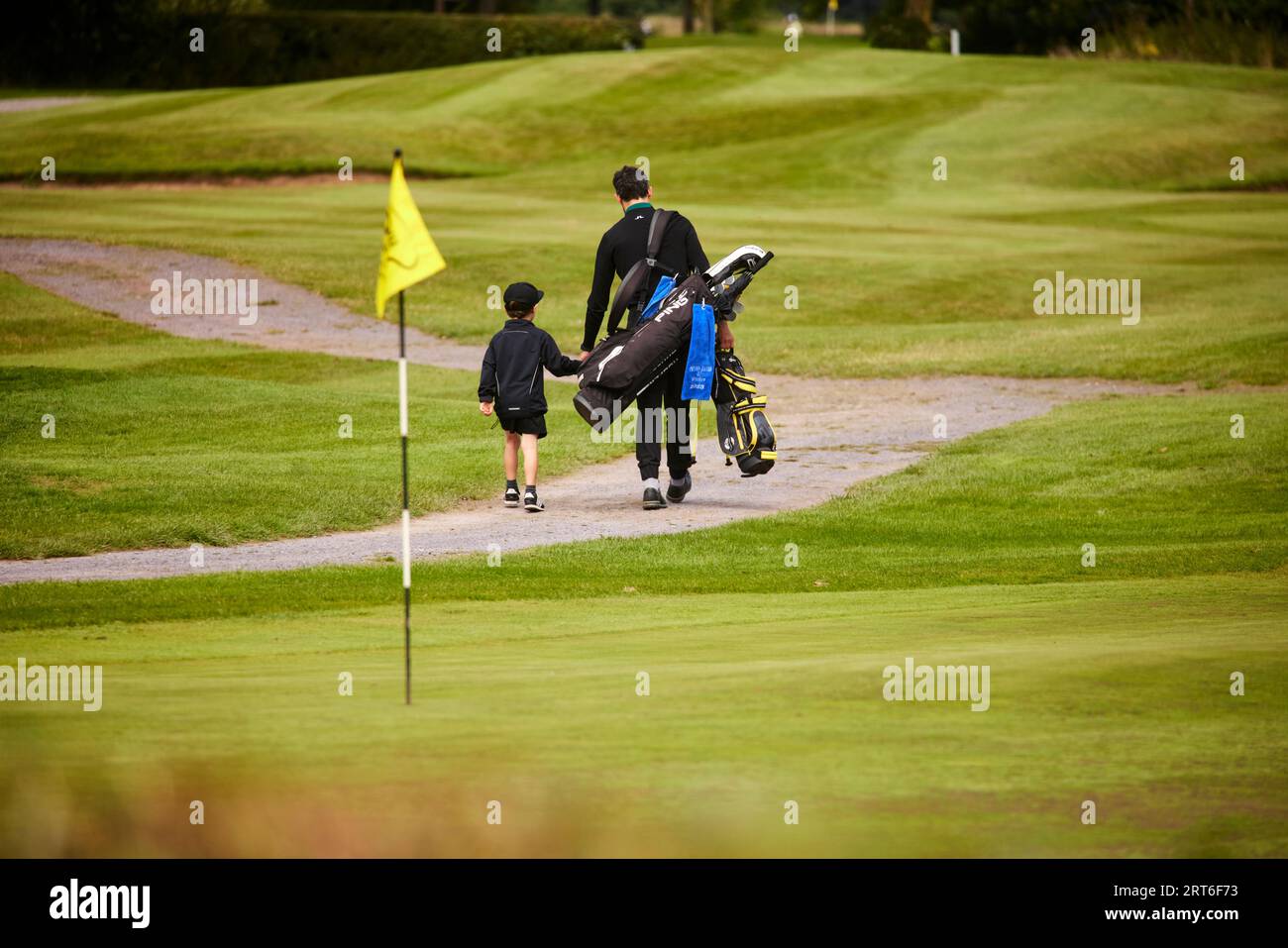 Father son playing golf together Stock Photo