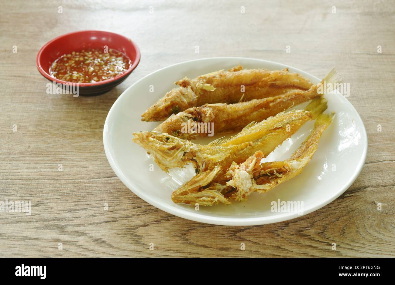 crispy fried sand whiting fish arranging on plate dipping spicy chili sauce in cup Stock Photo
