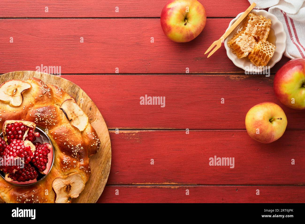 Jewish Holidays - Rosh Hashanah or Rosh Hashana. Pomegranate, apples, honey and round challah on  old wooden red table background. Jewish Autumn celeb Stock Photo