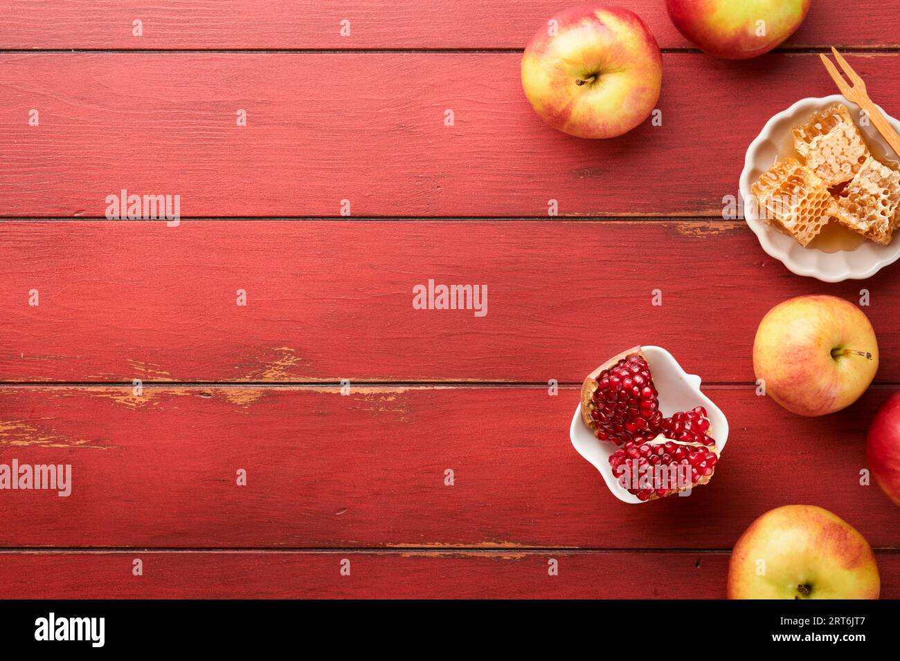 Jewish Holidays - Rosh Hashanah or Rosh Hashana. Pomegranate, apples, honey and round challah on  old wooden red table background. Jewish Autumn celeb Stock Photo