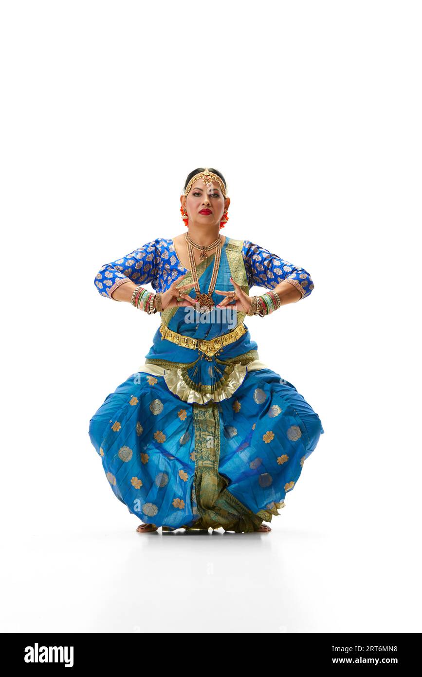 Indian beautiful woman dancing traditional dance in elegant blue dress  against white studio background Stock Photo - Alamy