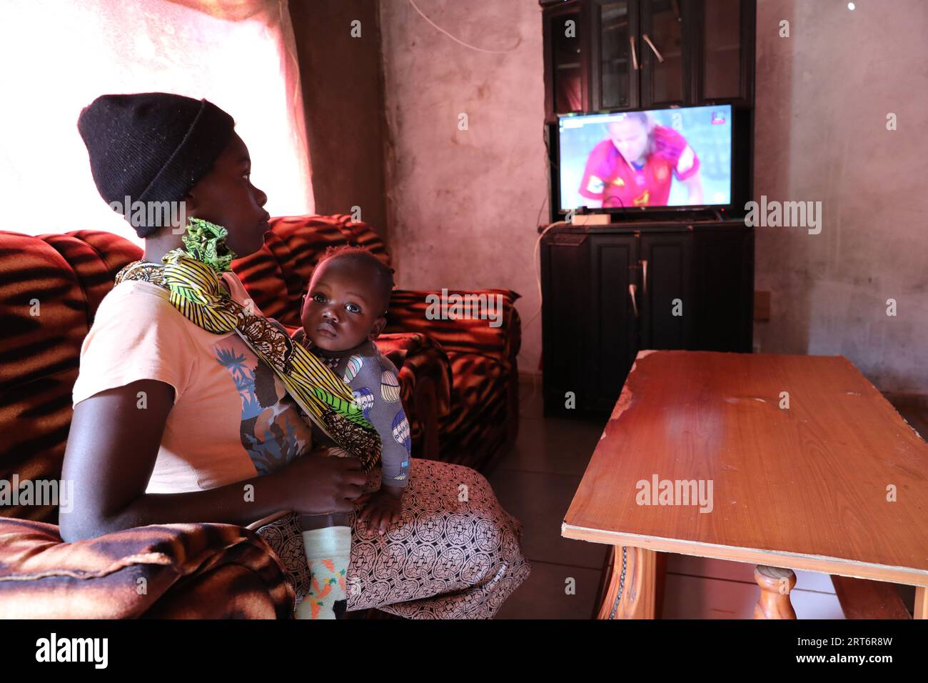 (230911) -- MAPUTO, Sept. 11, 2023 (Xinhua) -- A villager watches a satellite television program at home in Goba Village, Maputo Province, Mozambique, July 26, 2023. Government of Mozambique announced in May 2020 the completion of a project to bring digital satellite television signal to 1,000 villages in the country, which has benefited over 20,000 families.   The project, covering all the ten provinces and the capital city of Mozambique, was co-funded by China and implemented by the Chinese electronics and media company StarTimes. It trained work force particularly young people to be in char Stock Photo