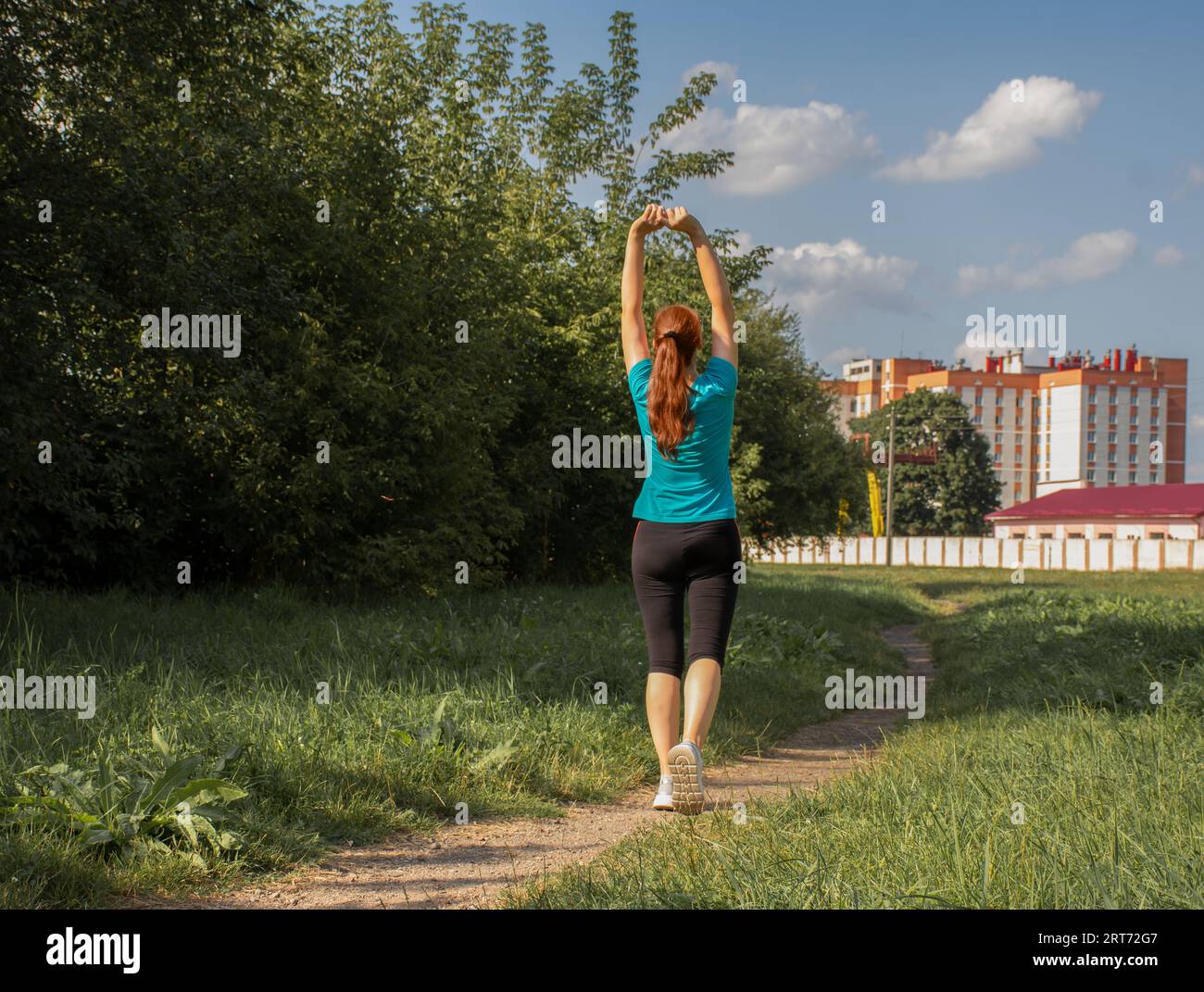 Beautiful mature woman in a sport wear in the park on a sunny day