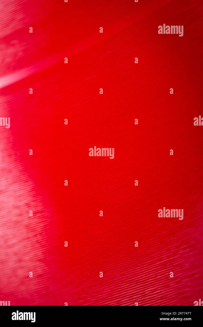 Macro shot of red color vinyl record. Surface of an old vinyl record. Shallow depth of field. Stock Photo