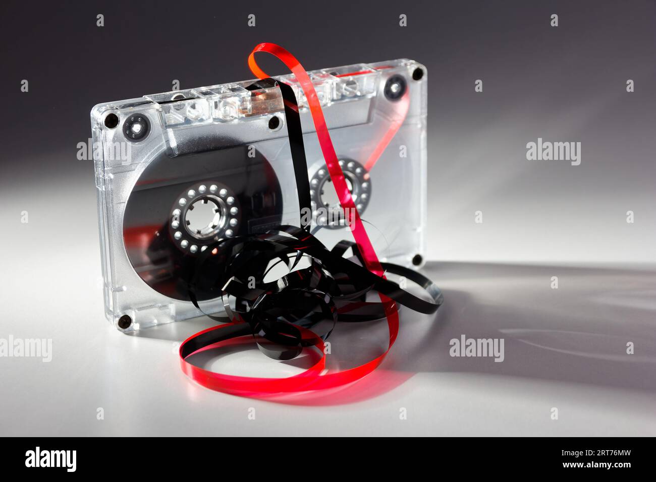 vintage analog audio cassette with transparent case and jammed tape