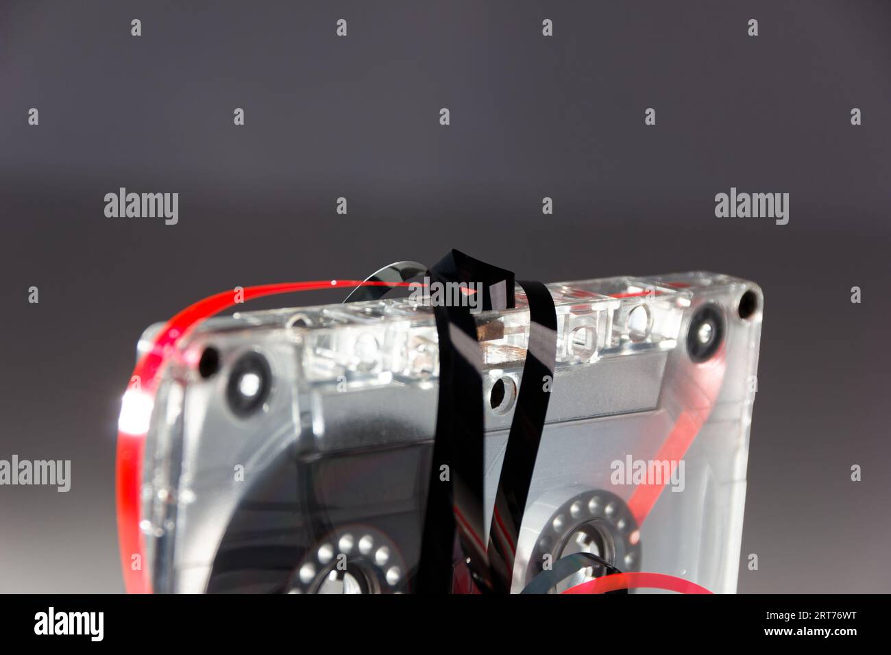 vintage analog audio cassette with transparent case and jammed tape