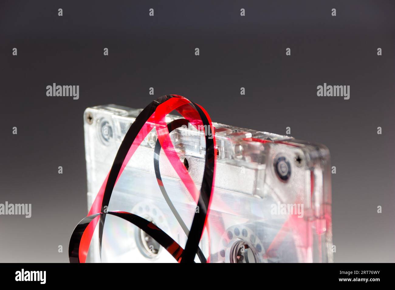 vintage analog audio cassette with transparent case and jammed tape