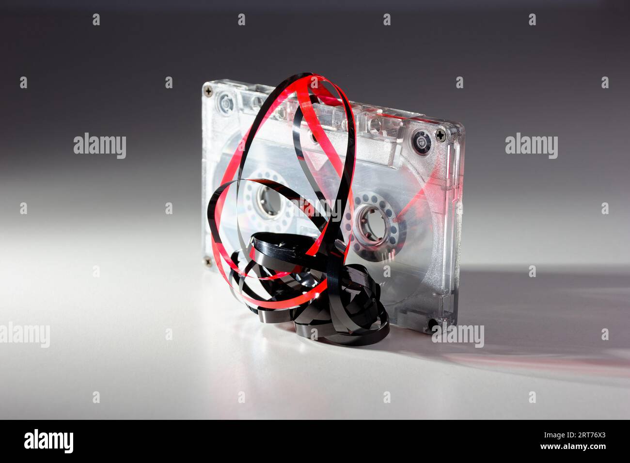 vintage analog audio cassette with transparent case and jammed tape