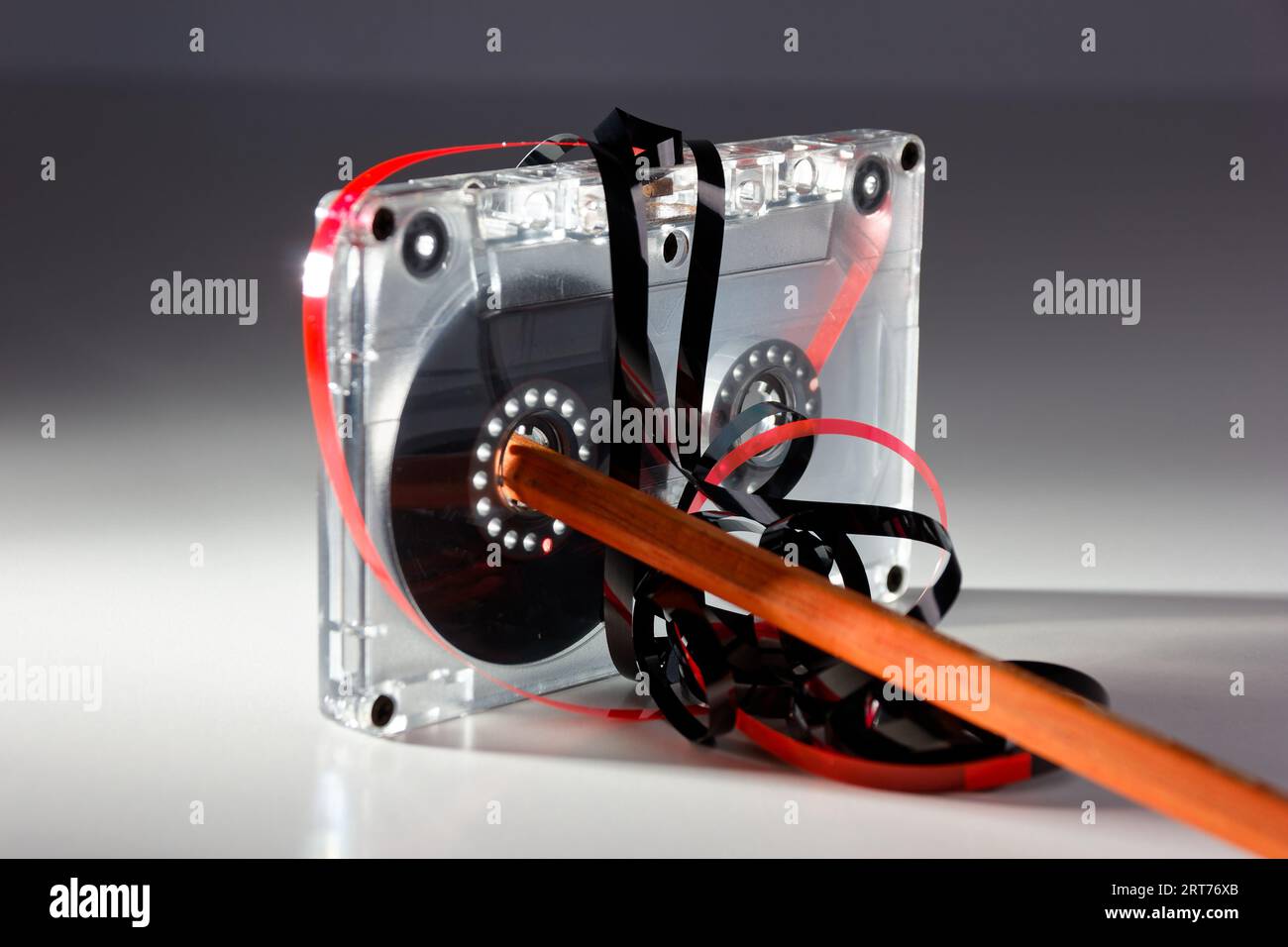 vintage analog audio cassette with transparent case, jammed tape and